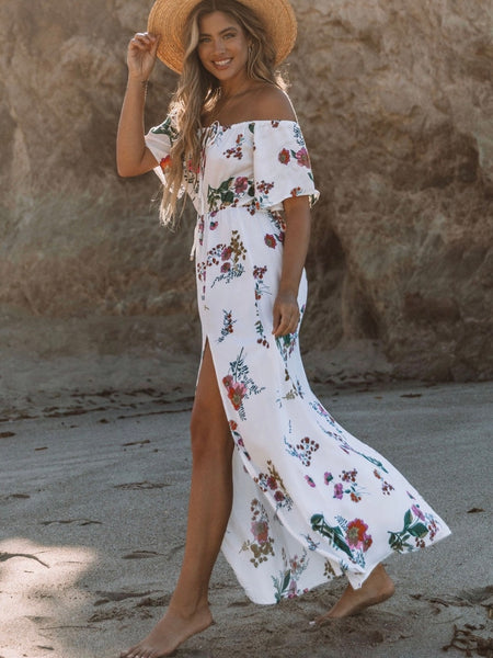  Printed Floral Maxi Dress in cream with adjustable halter tie neck off the shoulder style and front slit detail.