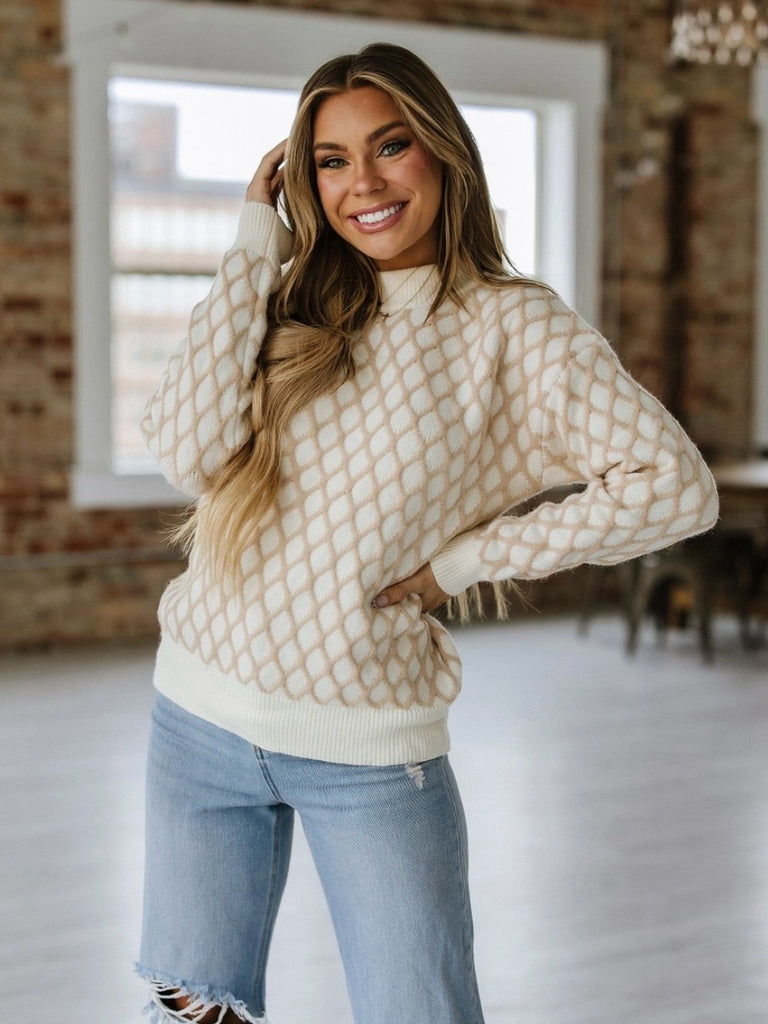 Cream and Beige Argyle pattern  Sweater has a soft rib-knit texture .