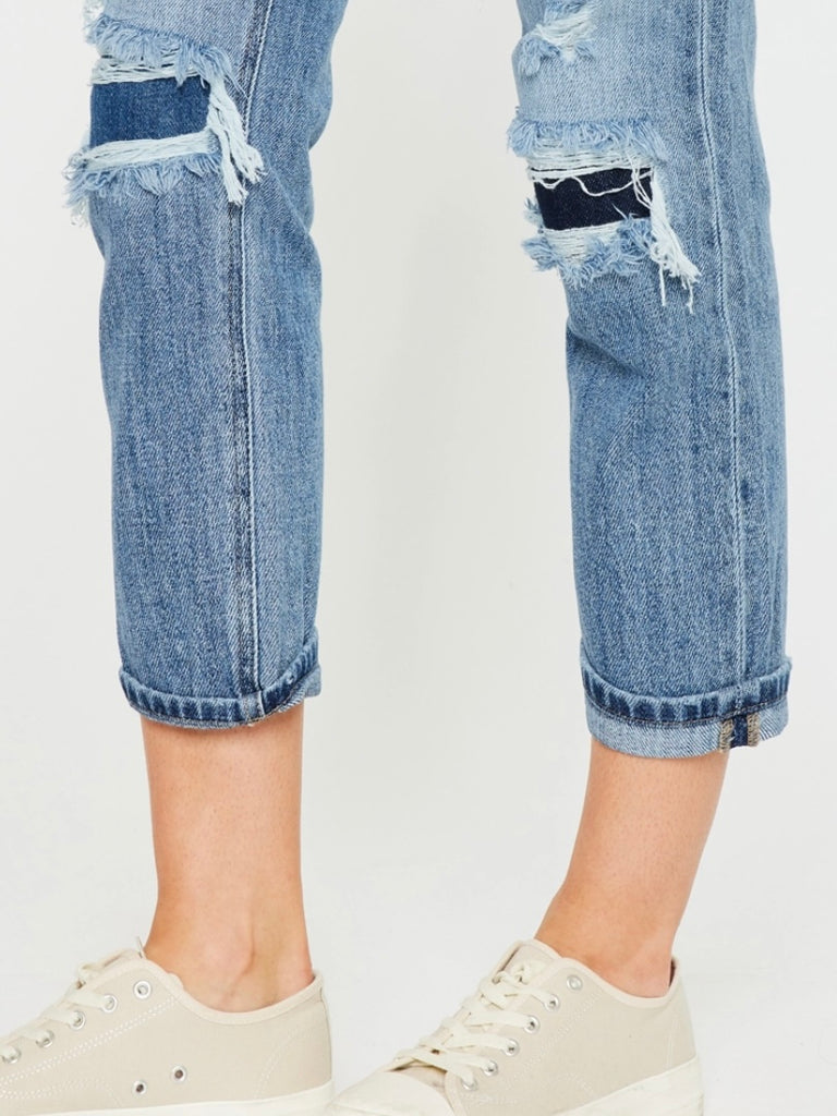 High Waisted ,5 Pocket Single Button Front and zip-fly Jean, with Light Fading and 3d Whisker detail , and moderate destruction with patches on both legs .