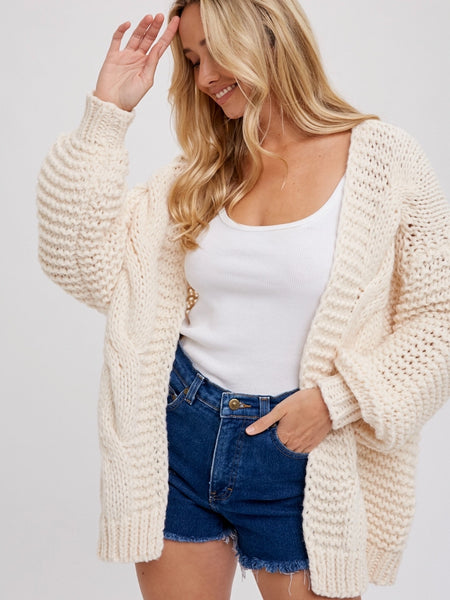 Cream Chunky Cable Cardigan with long batwing sleeves and unique braid pattern, it's an oversize fit.