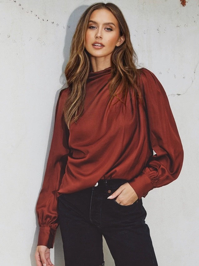 Claret coloured cinch blouse , Features a mock neck, and keyhole closure . Pleating detail on the shoulders and triple buttoned cuffs