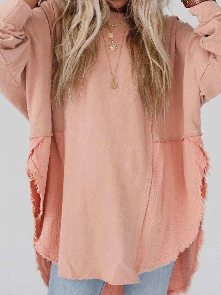 Pink Colour high-low tunic length and split hem pullover, features a round neckline and long sleeves, blend of crinkled gauze and knit, and raw edge design.