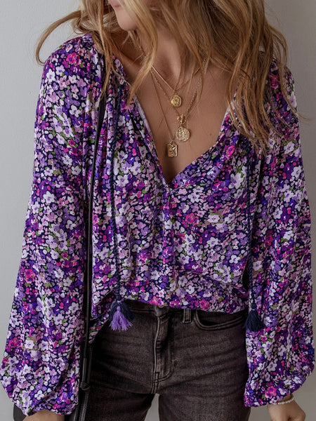  Boho-inspired blouse features a trendy tie front and beautiful floral print with bubble sleeves.