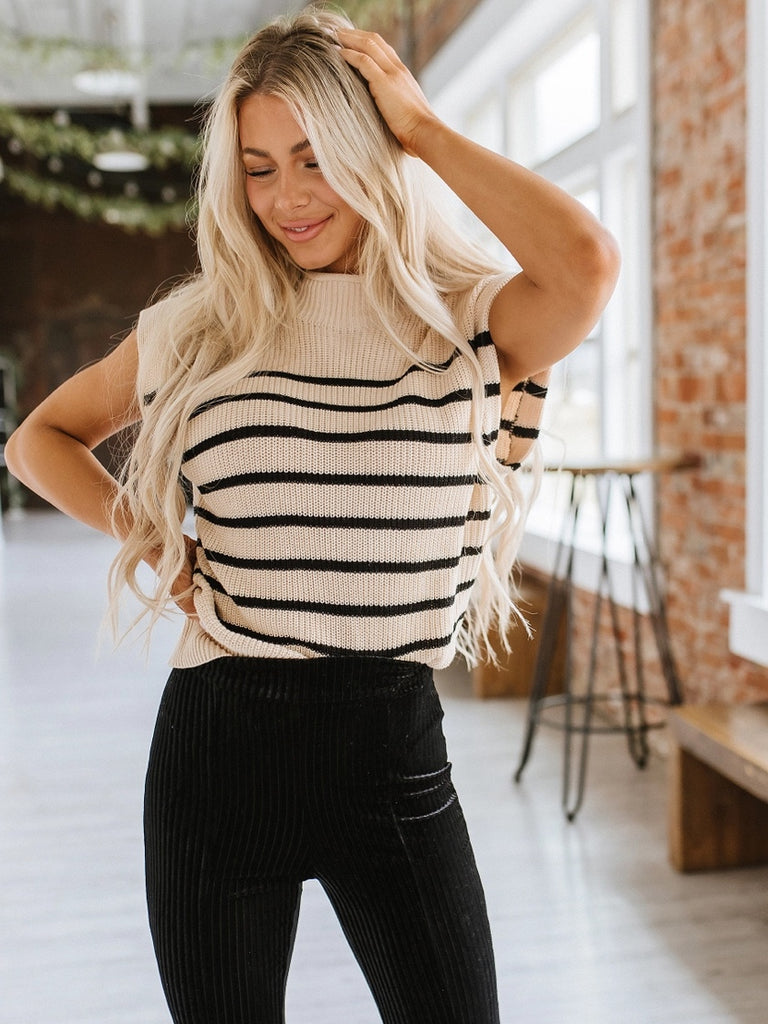 Mock neck striped sleeveless sweater.