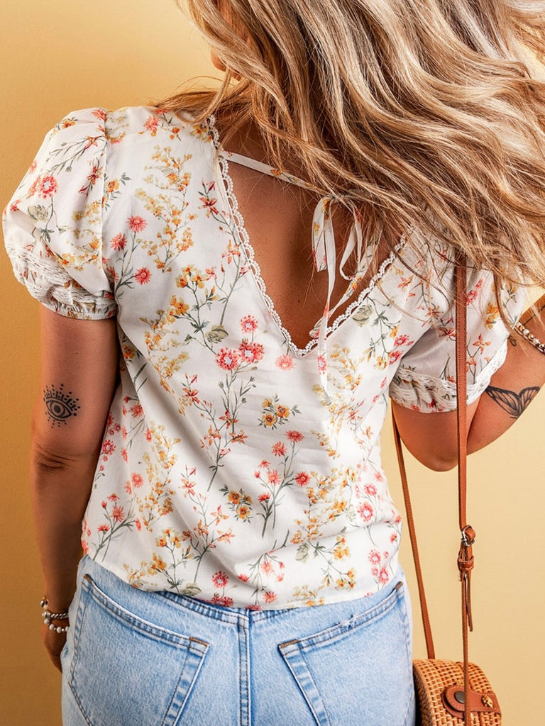 Floral V-neck front and back with a  little tie on the back and lacey details.