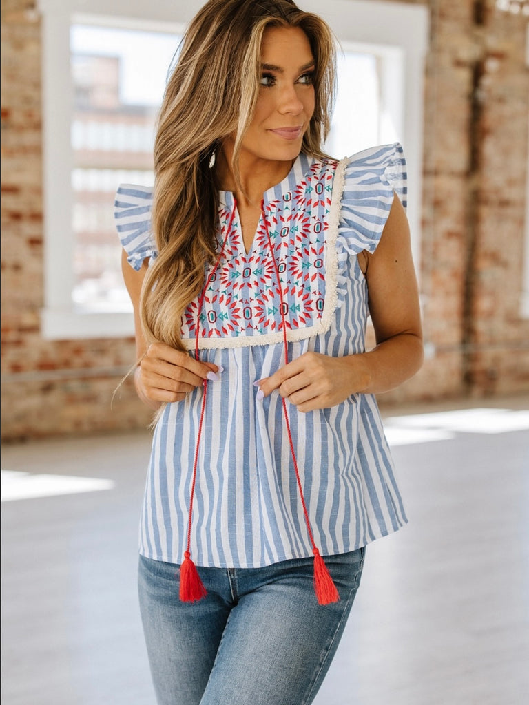 Delicate embroidery Top with cute striped design and notched neckline with tassel strings and flutter sleeves make for a relaxed fit.