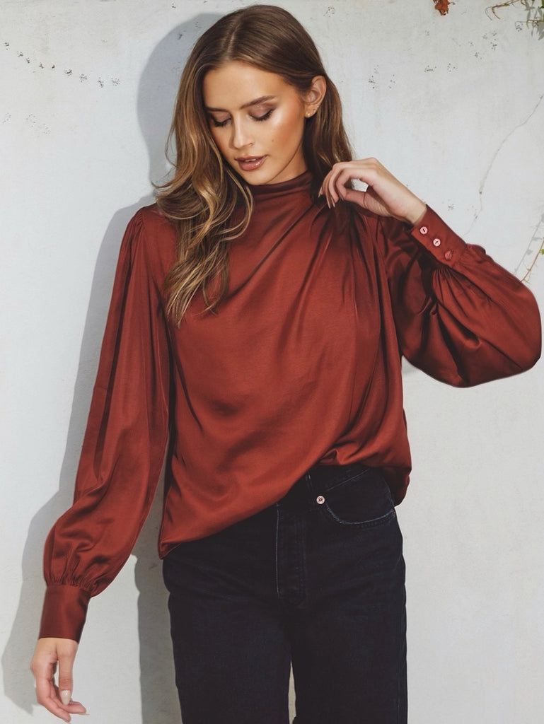 Claret coloured cinch blouse , Features a mock neck, and keyhole closure . Pleating detail on the shoulders and triple buttoned cuffs