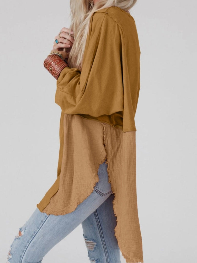 Camel Colour high-low tunic length split hem pullover, features a round neckline and long sleeves, blend of crinkled gauze and knit, and raw edge design.