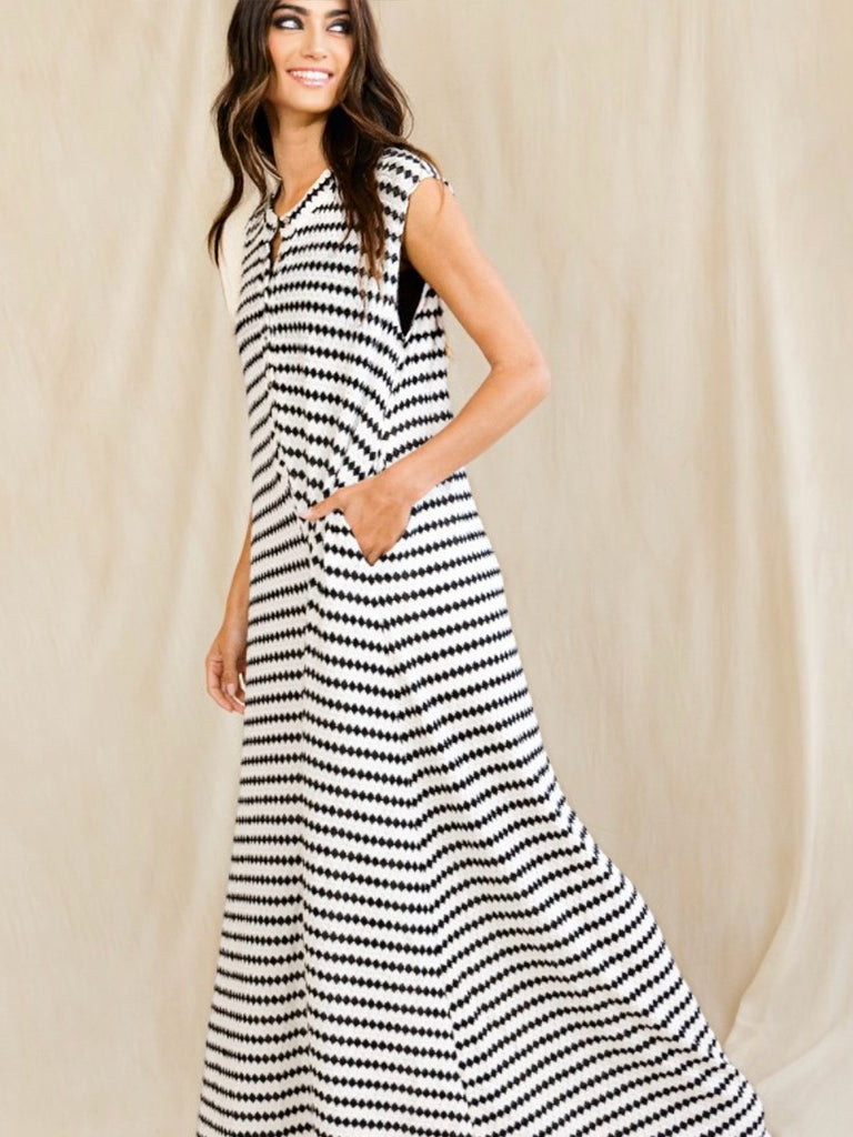 Made from yarn-dyed stripe knit fabric, this sleeveless jumpsuit features a button closure at the front, a rounded neckline, and wide leg design.