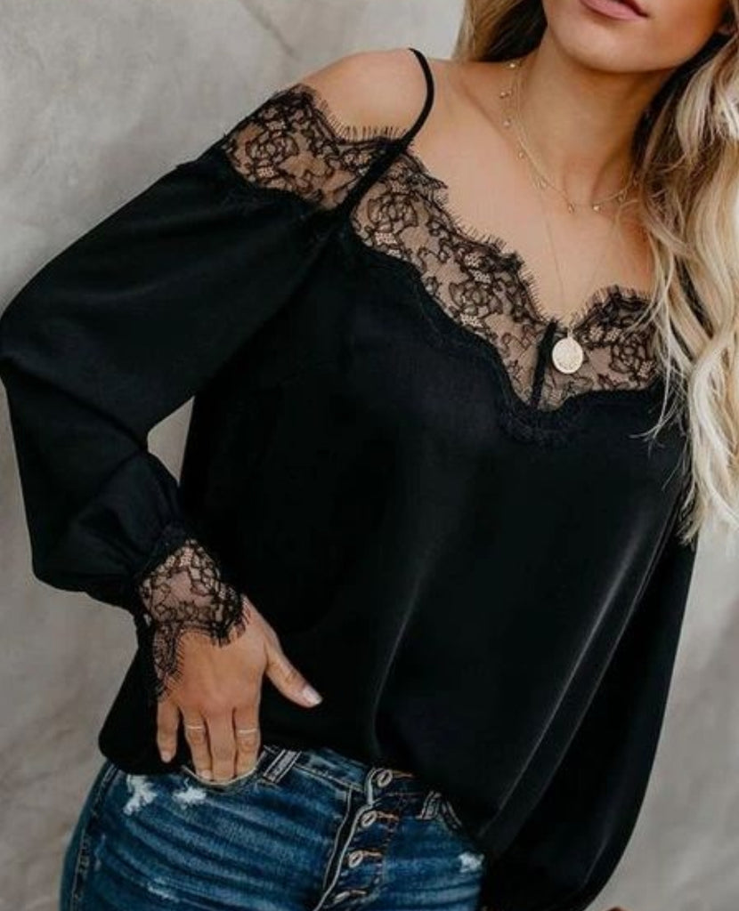 Black long Sleeve Top featuring dainty lace accents on the wrists and neckline, along with spaghetti straps, and a plunging back.