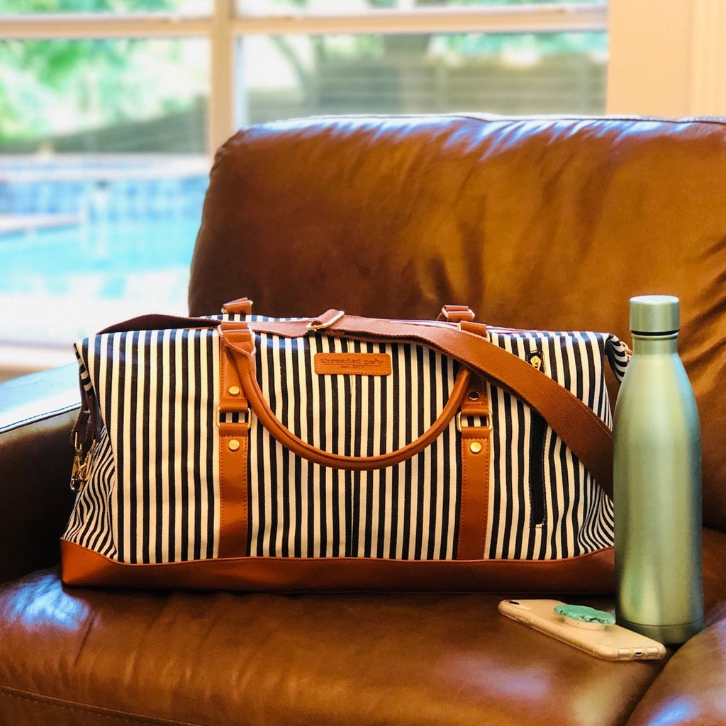 Classic Black Stripe Weekender Duffle Bag Made from durable, anti-wrinkle canvas, and has 2 handles and a long strap for over the shoulder carrying.