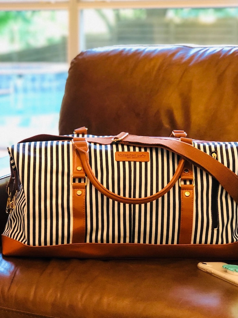 Classic Black Stripe Weekender Duffle Bag Made from durable, anti-wrinkle canvas, and has 2 handles and a long strap for over the shoulder carrying.