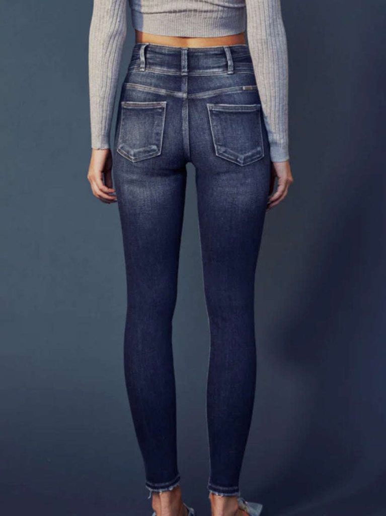 Super Skinny Fit, High Rise Jeans with heavy whiskering, and a double waistband, featuring classic five-pocket design, double-button front, and zip-fly closure.