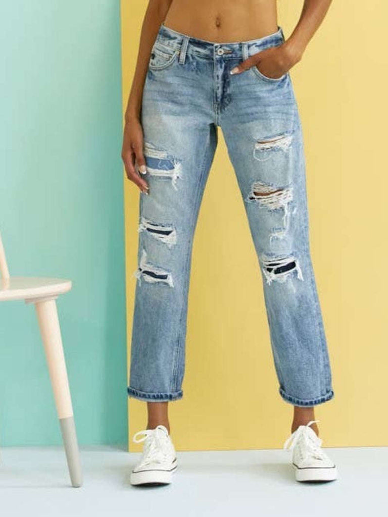 High Waisted ,5 Pocket Single Button Front and zip-fly Jean, with Light Fading and 3d Whisker detail , and moderate destruction with patches on both legs .