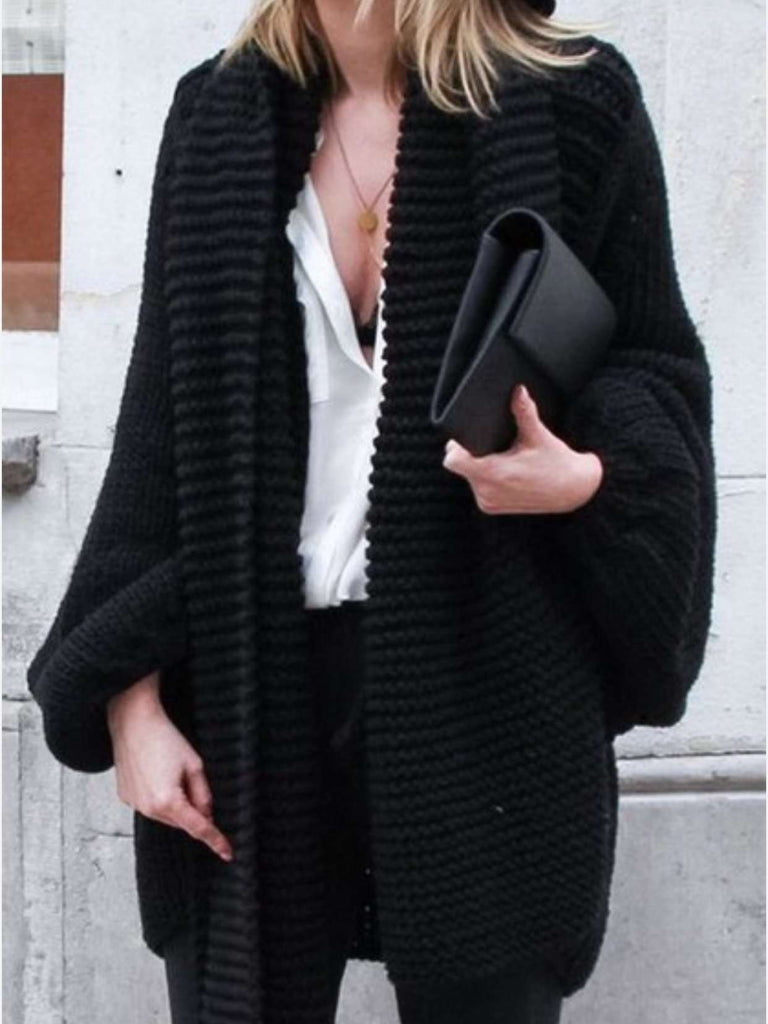 Black cardigan featuring a relaxed fit, loose sleeves and an open front.