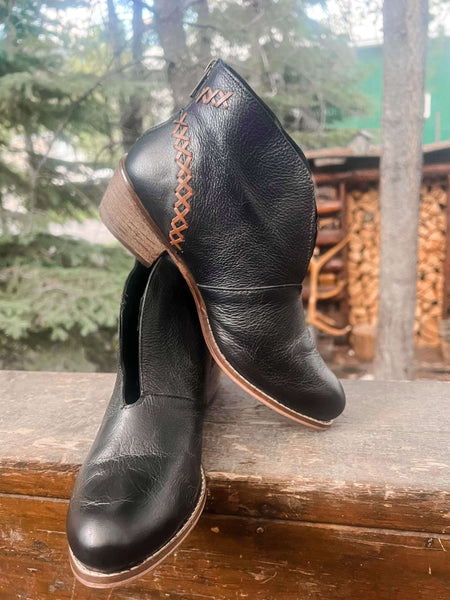  Black leather, ankle bootie with heavy stitching on the upper ,top pattern has an attractive V plunge. Zipper in the back, and a stacked heel measure 1.75 inches.