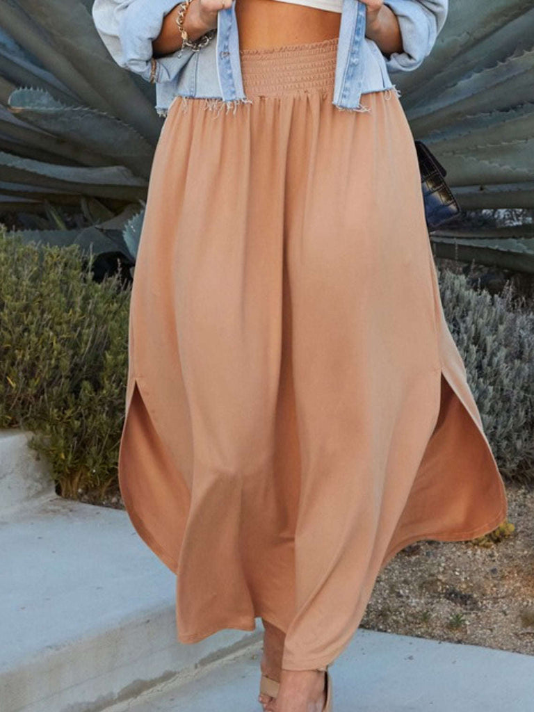 Camel Maxi- Skirt smocking waist band side slit and side pockets with rounded hem-line.