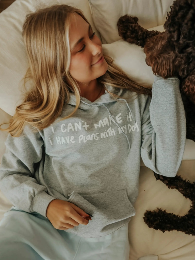 Grey "I can't make it I have plans with my dog" hoodie, with front pockets.