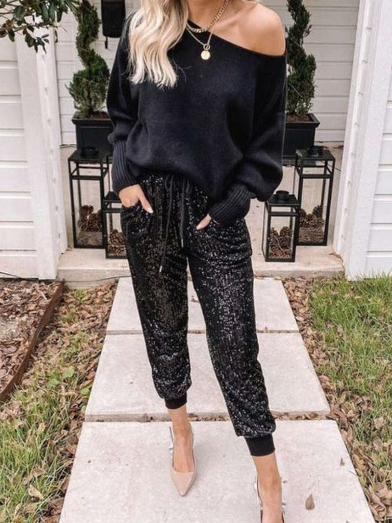  Stretchy sequin jogger pants feature an elasticated waist band and ankle cuffs and side pockets.