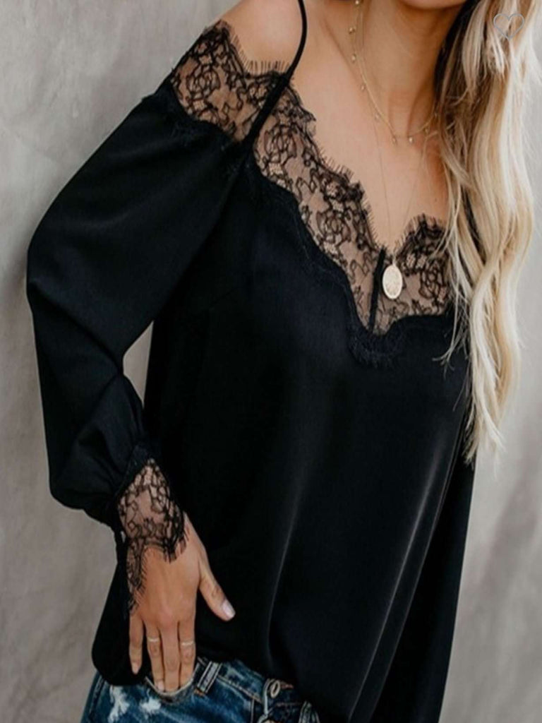 Black long Sleeve Top featuring dainty lace accents on the wrists and neckline, along with spaghetti straps, and a plunging back.