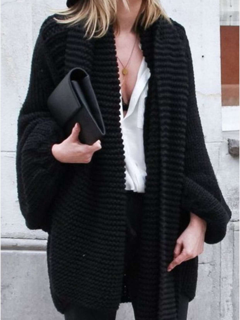 Black cardigan featuring a relaxed fit, loose sleeves and an open front.