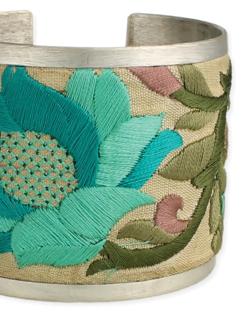 2" Wide Brushed Silver Cuff with bold cream coloured fabric embroidered with turquoise and purple floral designs.