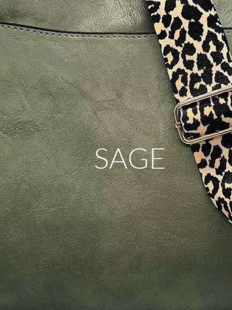 Sage Crossbody bag with leopard print strap. Made with vegan leather, it features a full zipper closure, an exterior back zip pocket, two open slip pockets, and a zipper pocket inside.