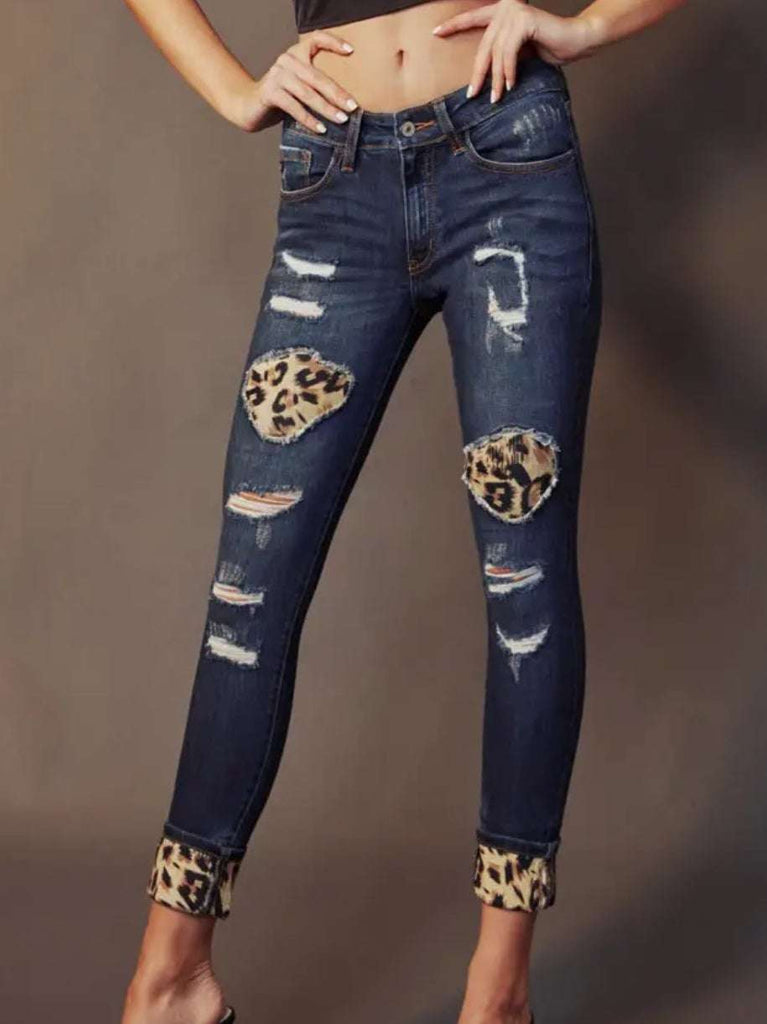 Leopard  skinny jeans by Kancan with patchwork leopard print and scattered distress design. 