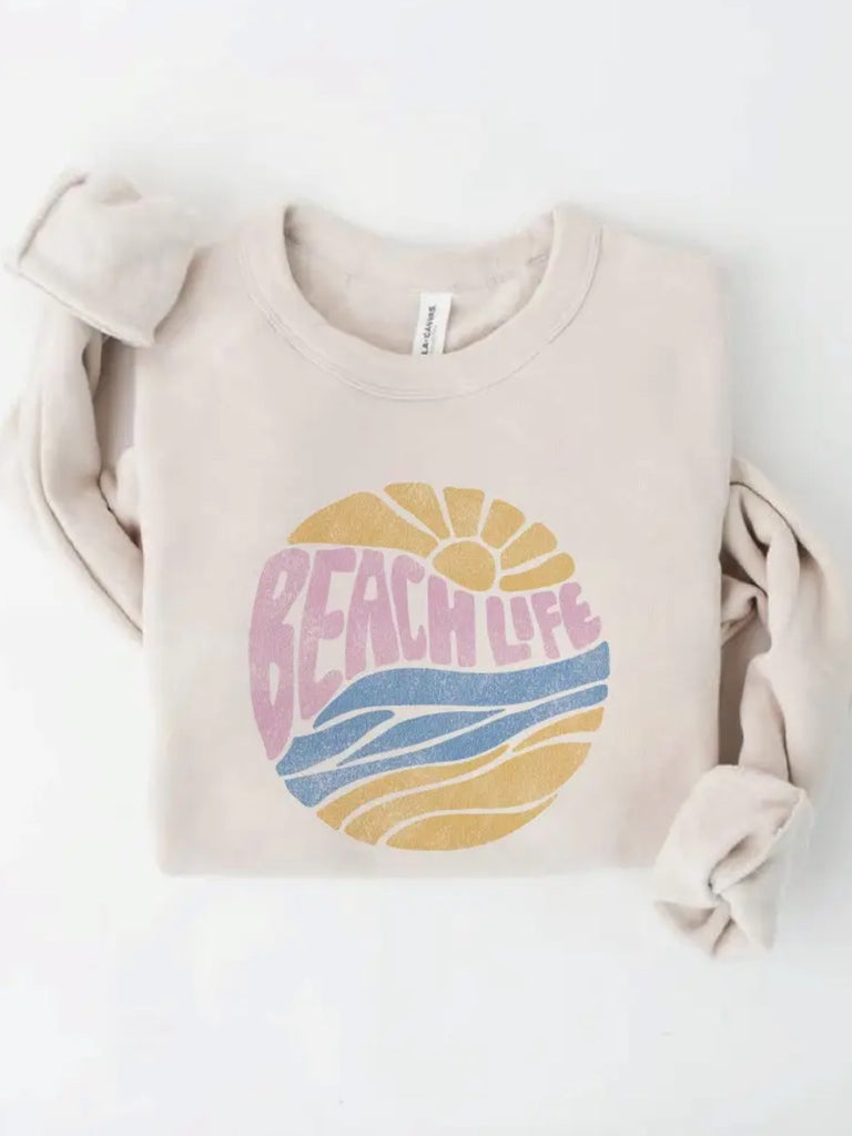 Featuring a soft vintage vibe beach life front graphic sweatshirt in pink, blue, and yellow ocean colours.