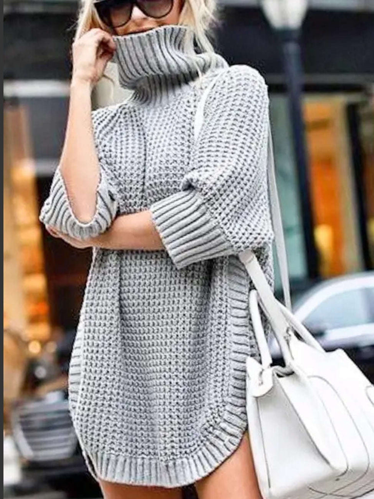  Grey Sweater with  turtle neck detail, and  it has 3/4 length sleeves and round tunic hem, side -slit with a thick thermos-textured knitting.