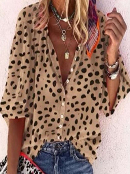 Leopard print, button front top has loose balloon style 3/4 sleeves with elastic wrists and is 100% polyester.