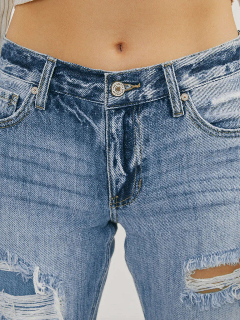 High Waisted ,5 Pocket Single Button Front and zip-fly Jean, with Light Fading and 3d Whisker detail , and moderate destruction with patches on both legs .