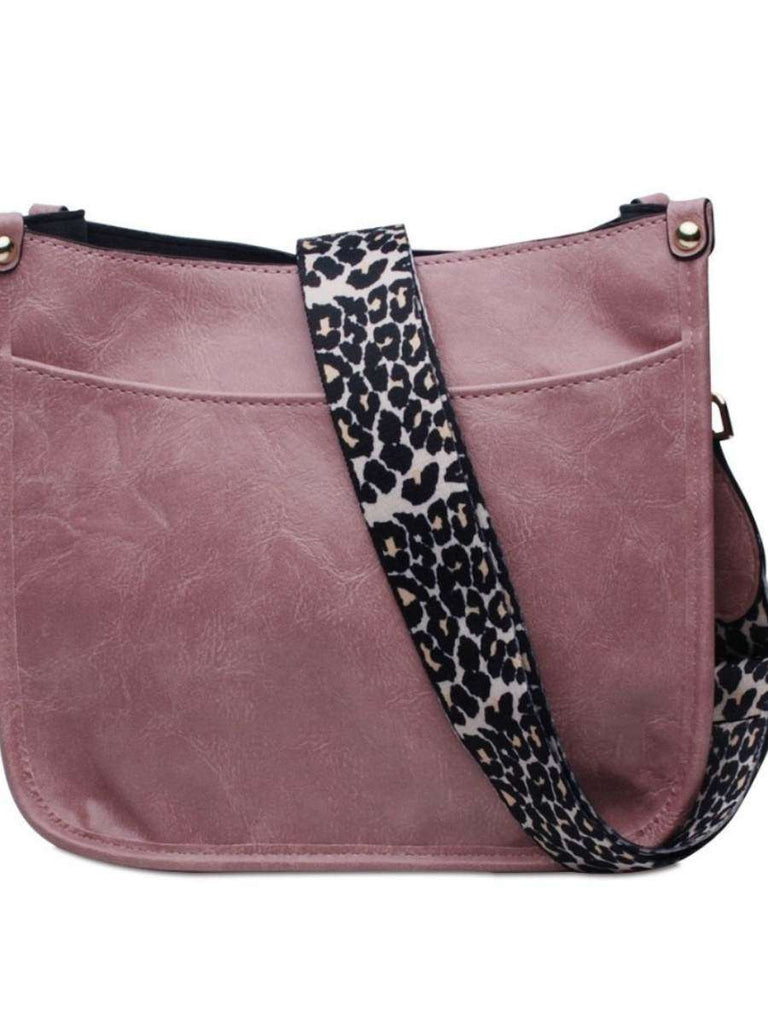 Pink  Crossbody bag with leopard print strap. Made with vegan leather, it features a full zipper closure, an exterior back zip pocket, two open slip pockets, and a zipper pocket inside.